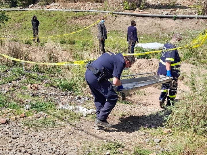 Forensic experts at the scene where they found the decomposed body of an unknown man.